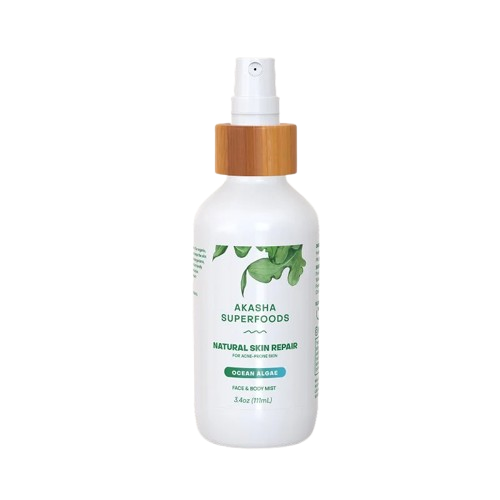 Natural skin repair spray bottle, black background.