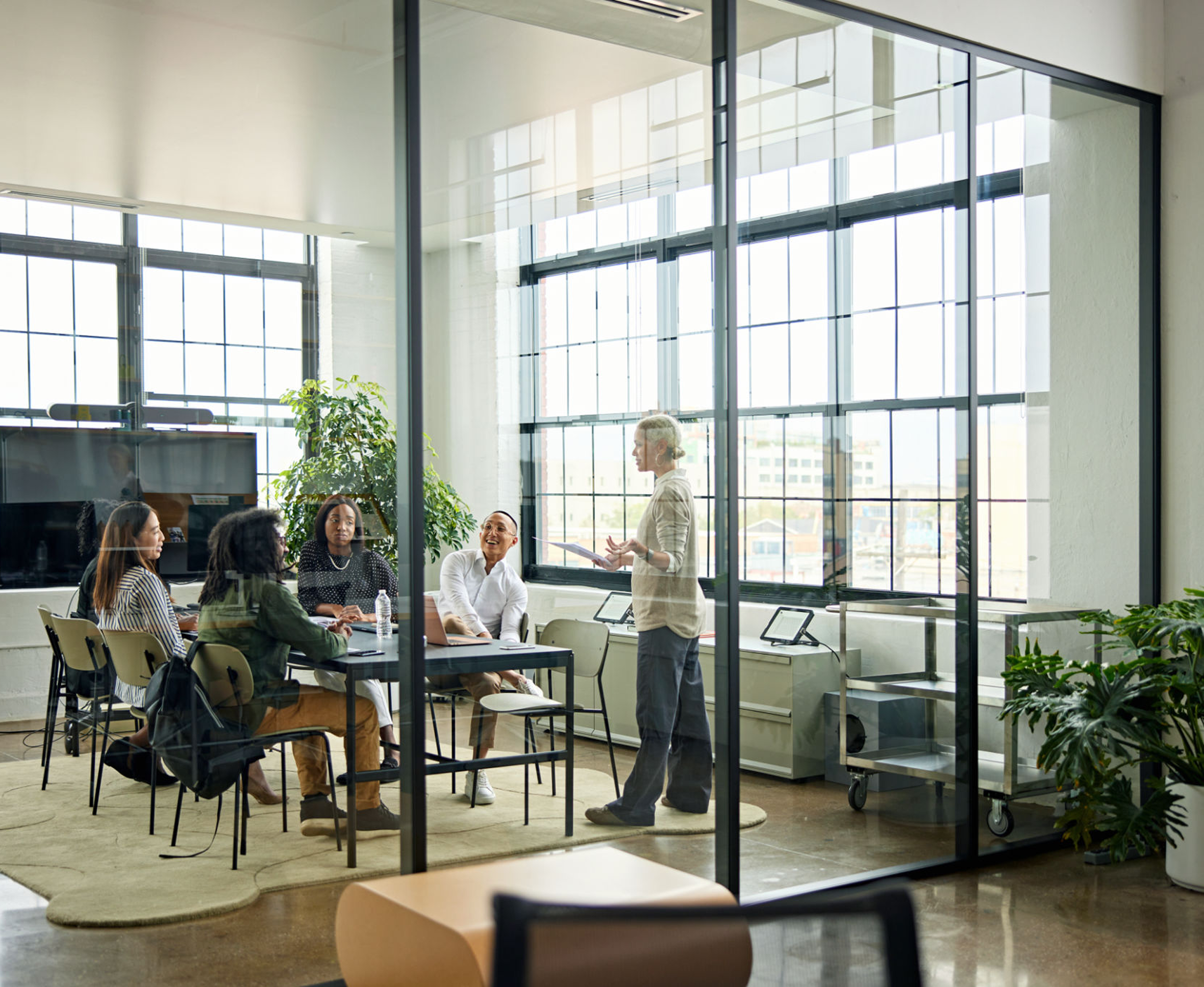 Team meeting in a modern glass office.