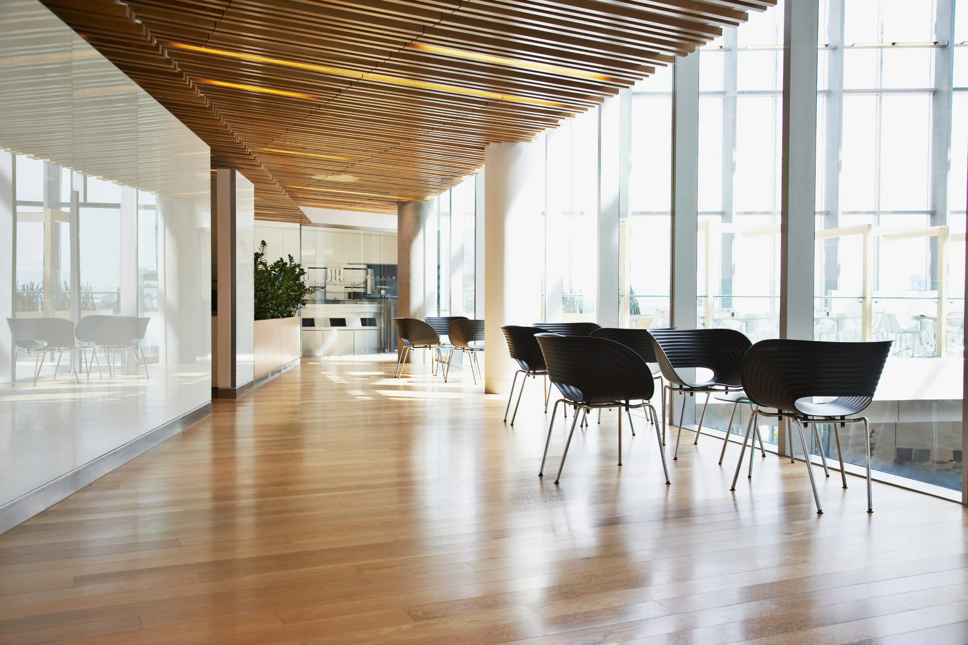 Modern office lounge with chairs and tables.