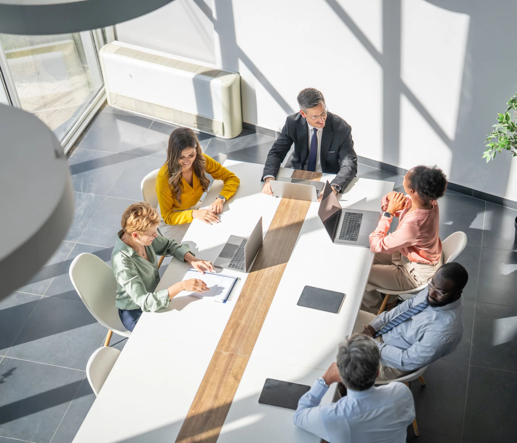 Business meeting with diverse team around table.